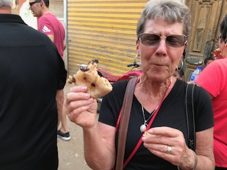 Kathy eating local bread made on the street