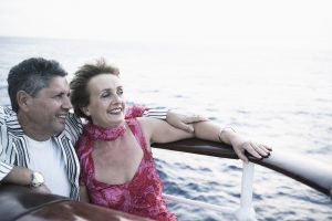 Mature woman and a senior man smiling in a ship that shows the top European Cruises for 2022